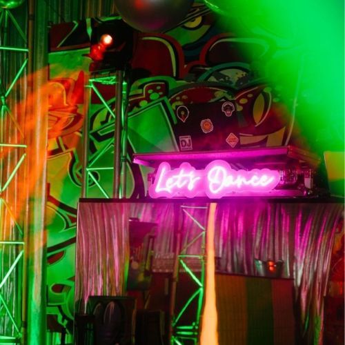 green party on dancefloor dj neon sign