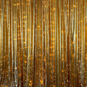 metallic gold drape with fairy lights close up 