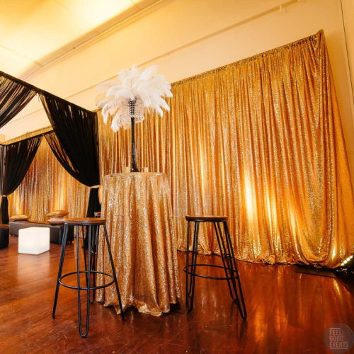 gold sequin draped wall with gold and black party guest lounge 