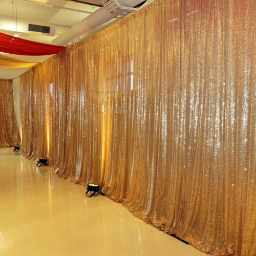 sequin gold draped hallway with up lighting