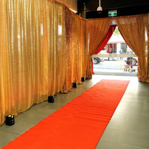 sequin gold drape party entrance way with red carpet