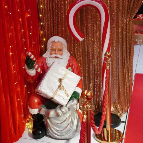 candy cane prop with santa statue