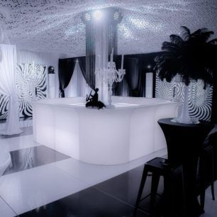 black and white themed photoshoot with white illuminated curved bar