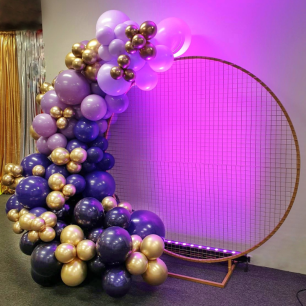 gold mesh round backdrop with purple balloon garland