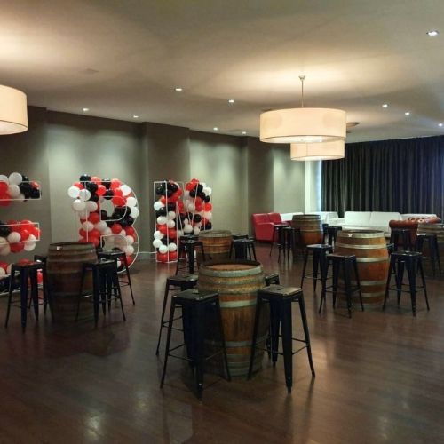 indoor party with bar bar stools around wine barrels