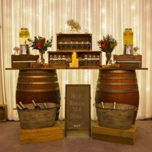 rustic wedding bar with wine barrels