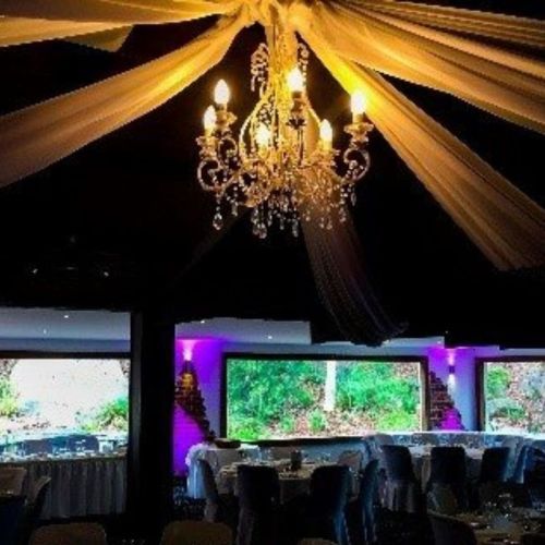 Chandelier hangs above dining tables at venue