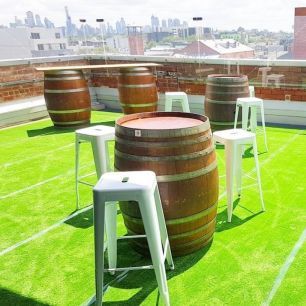rooftop wine barrels and black bar stools