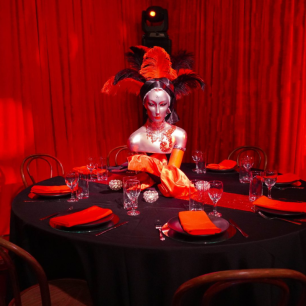 red burlesque mannequin red draped dining room