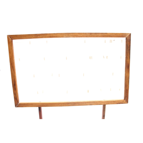 wooden frame with strings and pegs