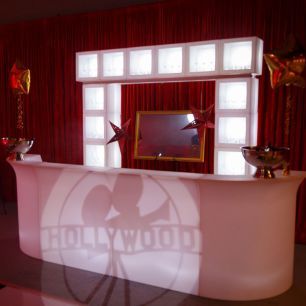 hollywood themed party with illuminated open cubes over bar