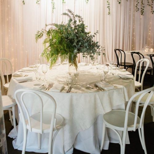 single round table at wedding venue greenery