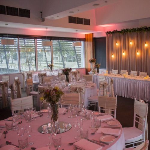 white wedding reception round dinner tables pink lighting