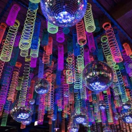 fluro slinkys hanging from ceiling with uv glow