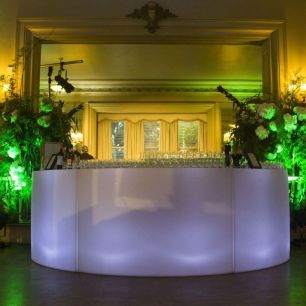yellow and green lighting illuminated curved bar