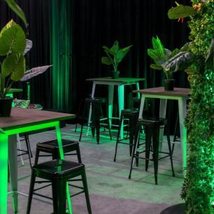 black bar stools around tolix bar tables with green lighting