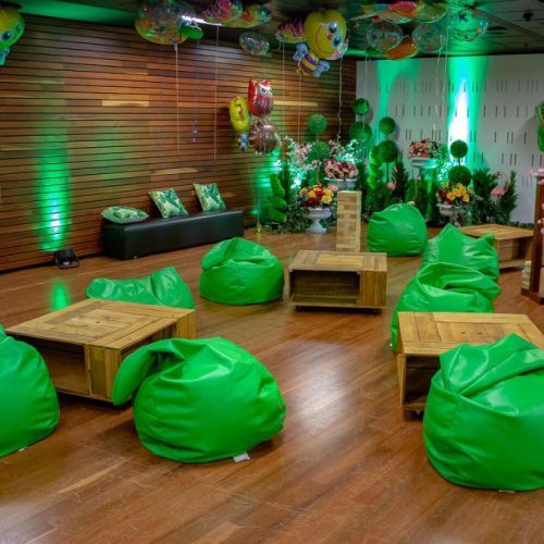 green beanbags around wooden coffee tables