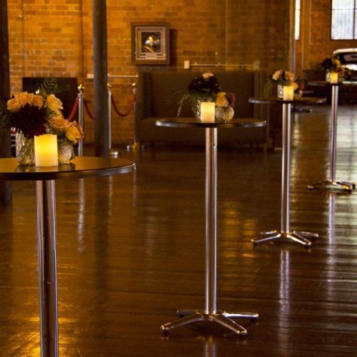 rustic wedding with black high bar tables with centrepieces