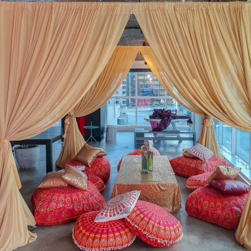 red and gold seating area with gold chiffon canopy