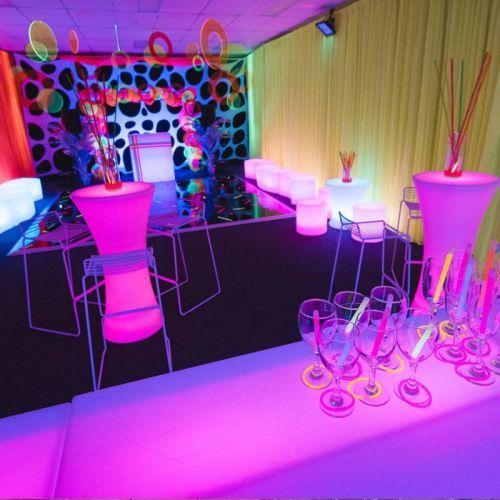 neon glow theme party photoshoot with white stools