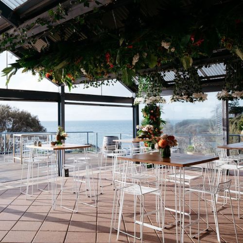 Coastal Wedding with White wire stools around high bar tables