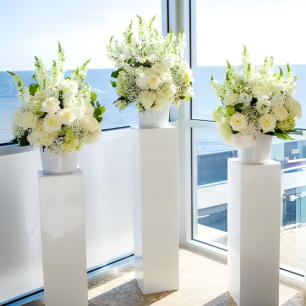white plinths with white floral centrepieces
