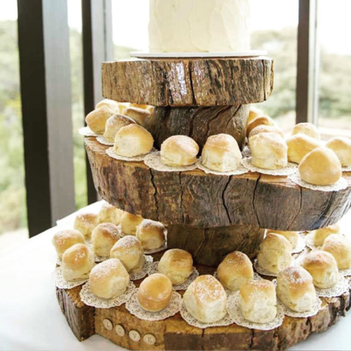 scones and cake on a rustic wooden cake stand